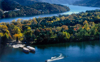 Scenic view of a waterbody and forested mountains in Nami Island, South Korea.