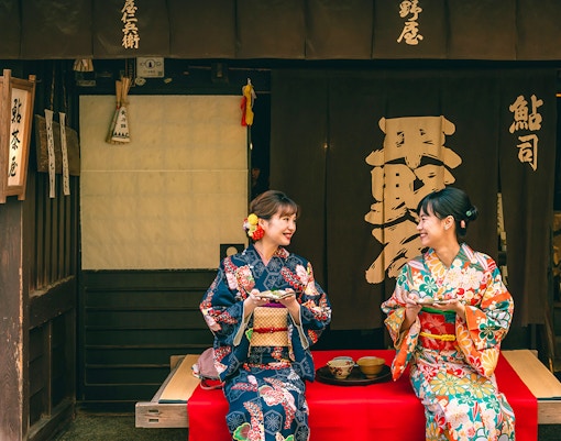 Kimono-clad individuals walking through Gion district, Kyoto, during full-day rental experience.