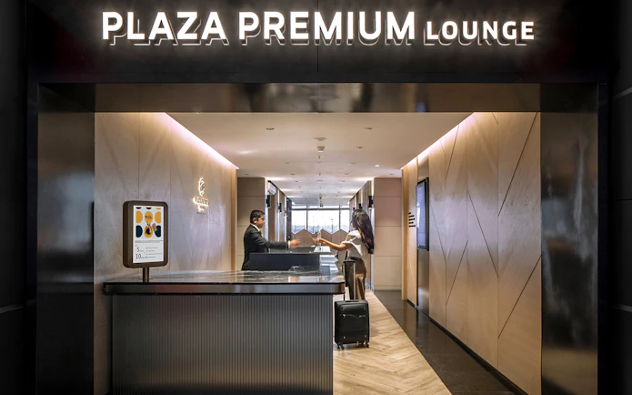 Plaza Premium Lounge entrance at Istanbul Ataturk Airport with reception desk.