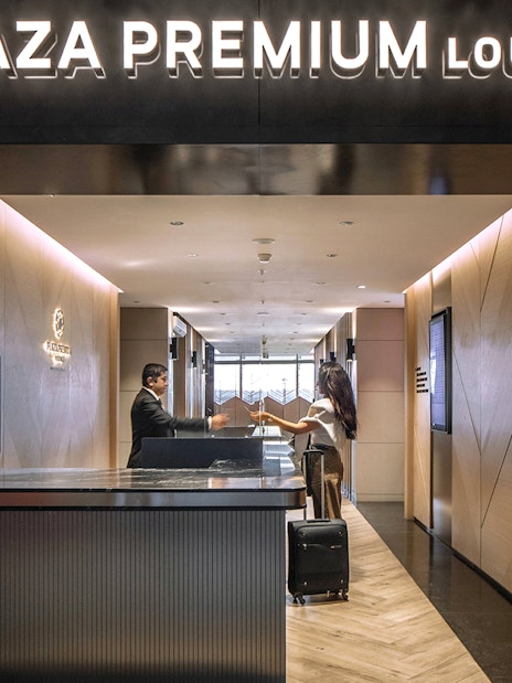 Plaza Premium Lounge entrance at Istanbul Ataturk Airport with reception desk.