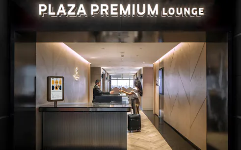 Plaza Premium Lounge entrance at Istanbul Ataturk Airport with reception desk.