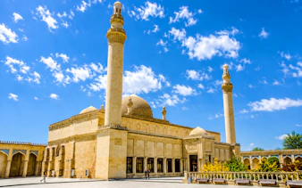 Khan's Palace in Sheki with minarets under a blue sky, part of Baku full-day tour.