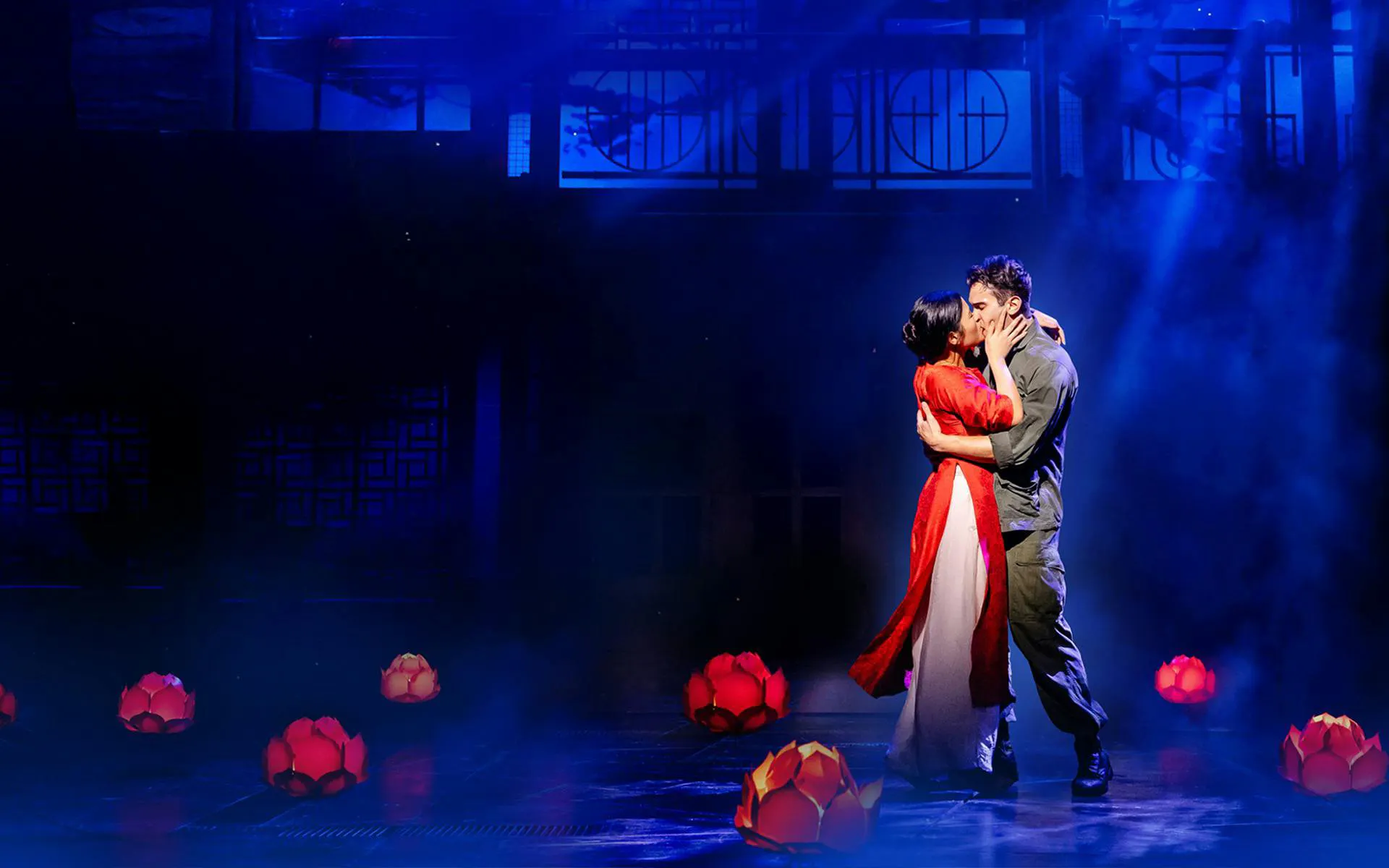 Miss Saigon performance with actors embracing on stage, West End.