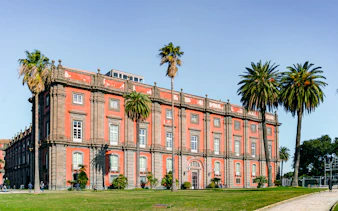 Capodimonte Museum exterior with palm trees, Naples, Italy.