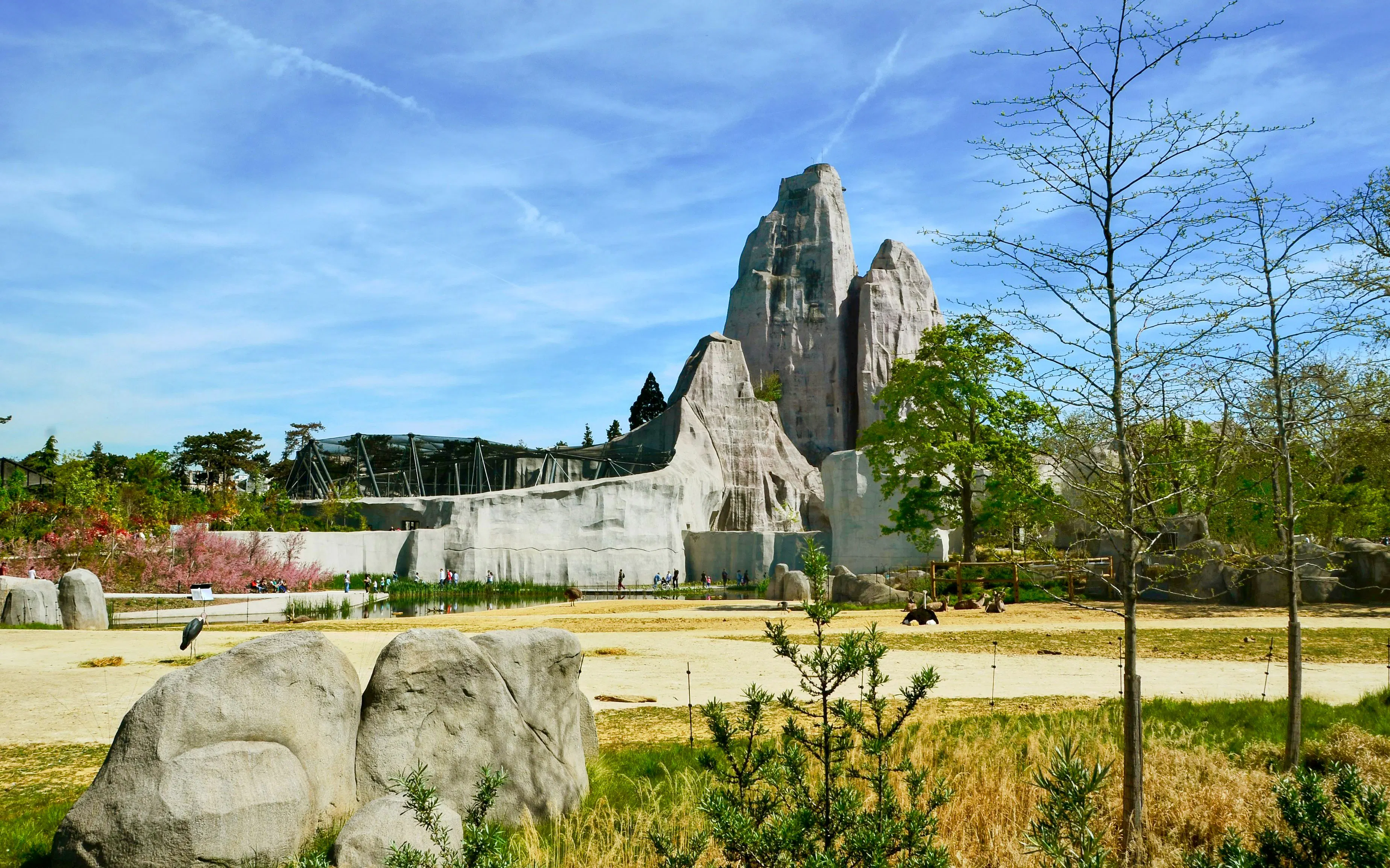 Zoo De Vincennes landscape with rock formations and greenery.