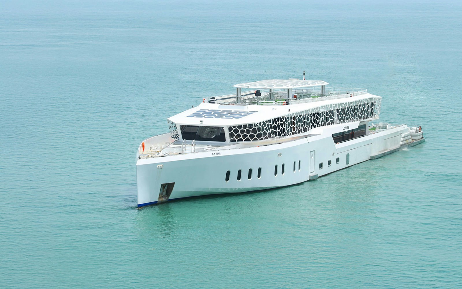 Lotus Mega Yacht cruising Dubai Marina with buffet dinner setup and live entertainment.