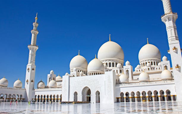 Sheikh Zayed Grand Mosque in Abu Dhabi with blue sky background.