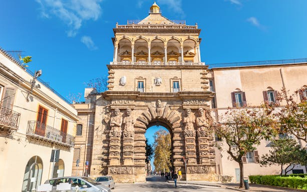 Porta Nuova in Palermo, Italy, showcasing its ornate stone arch and sculptures.