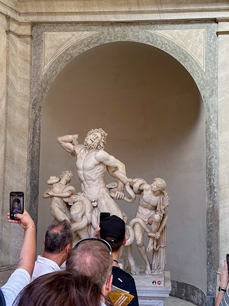 Tour group viewing Laocoön and His Sons statue in Vatican Museums.