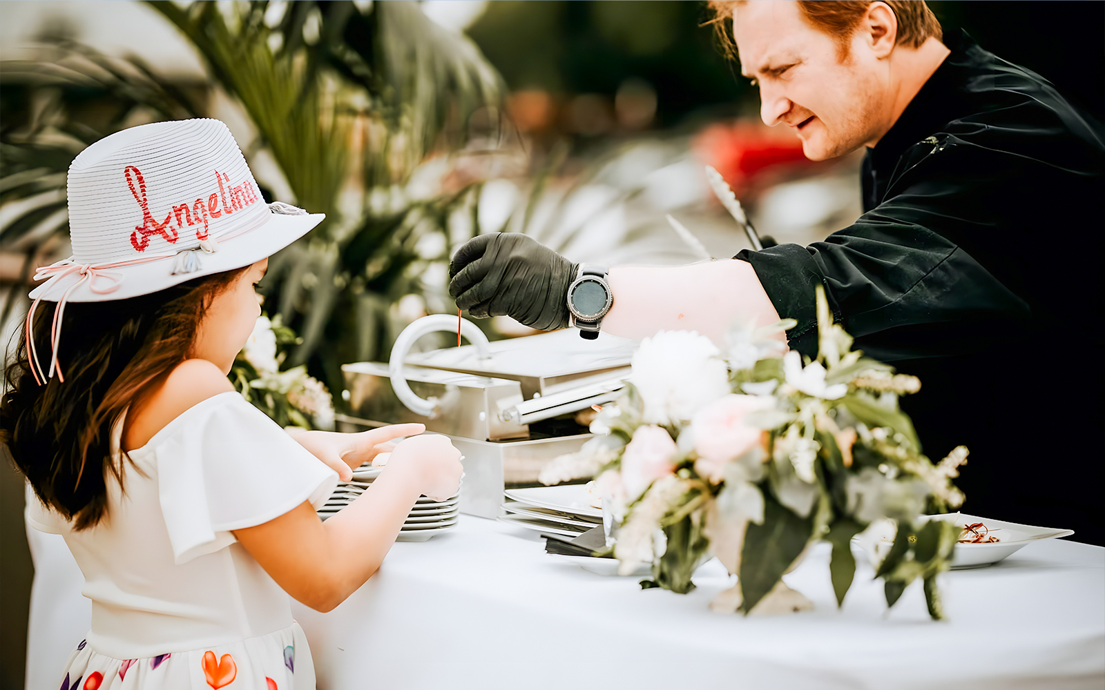 Chef serving food to a child on the Le Diamant Bleu Seine River cruise buffet.