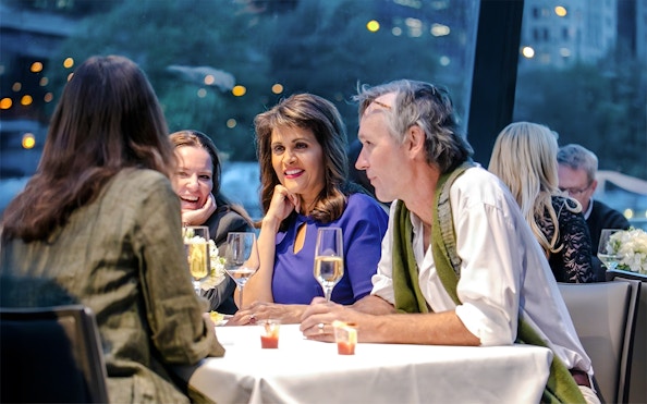 Group of friends enjoying wine on a Lake Michigan sunset cruise.
