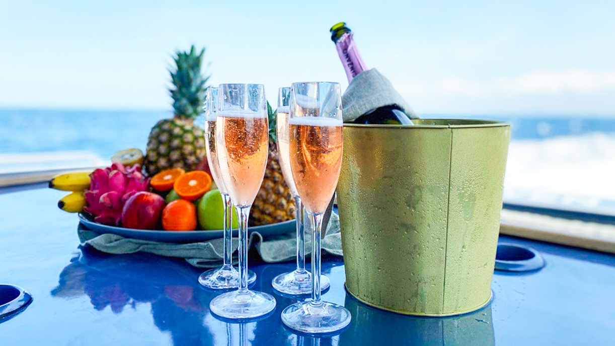 Nusa Penida & Manta Point Snorkelling Day Tour with tourists swimming in clear blue water near colorful coral reefs and tropical fish