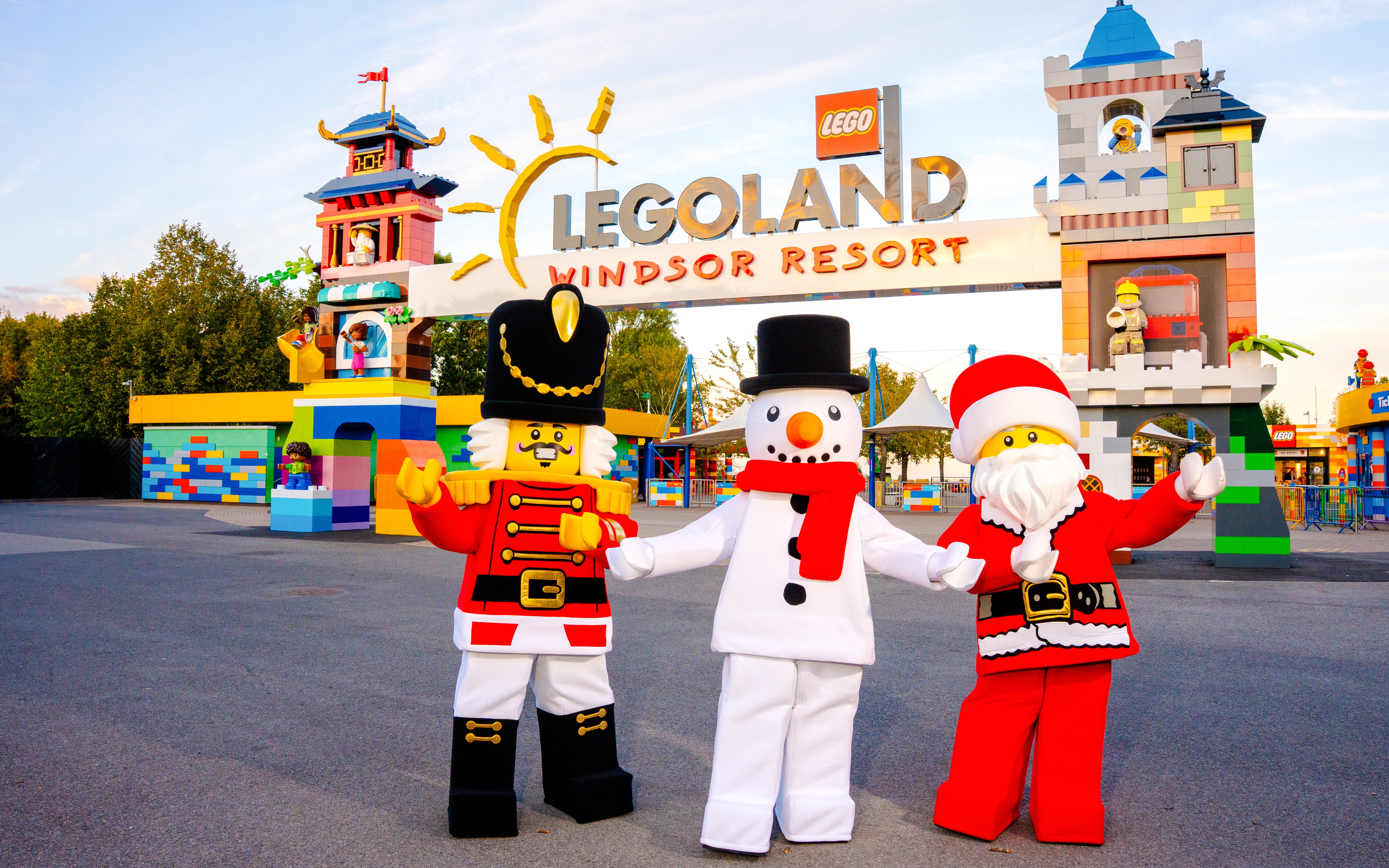 LEGO characters in Christmas costumes at LEGOLAND Windsor entrance.