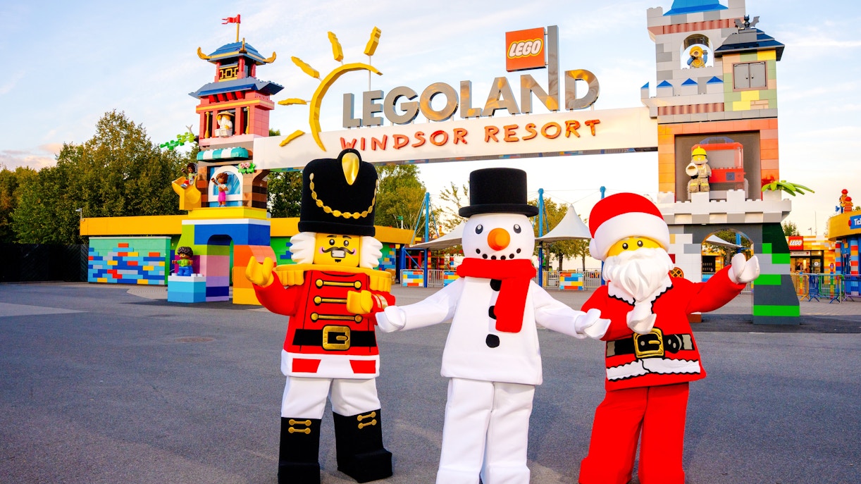 LEGO characters in Christmas costumes at LEGOLAND Windsor entrance.