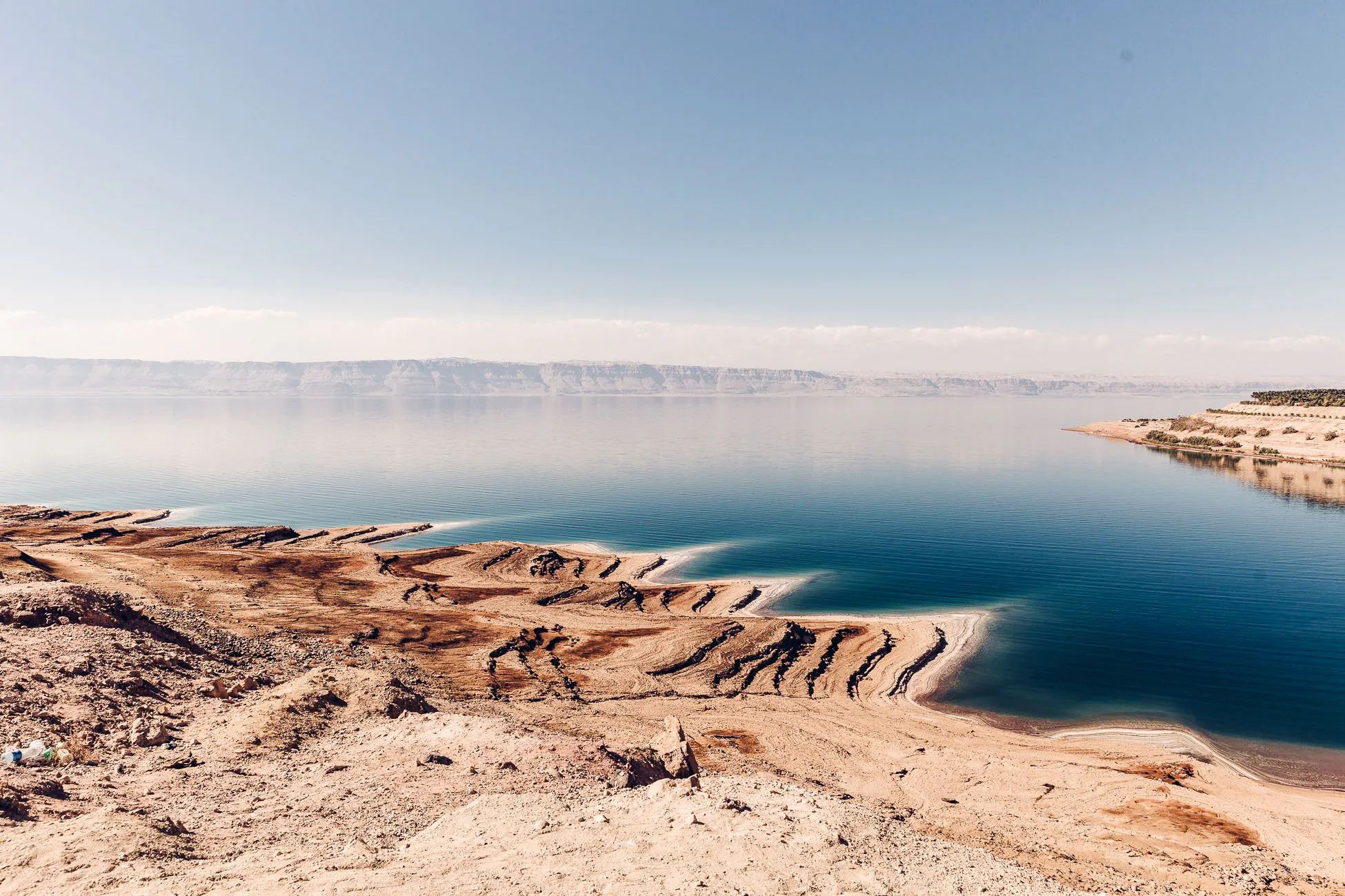 Dead Sea shoreline with salt formations, part of Amman: Petra, Wadi Rum, and Dead Sea 2-Day Tour.