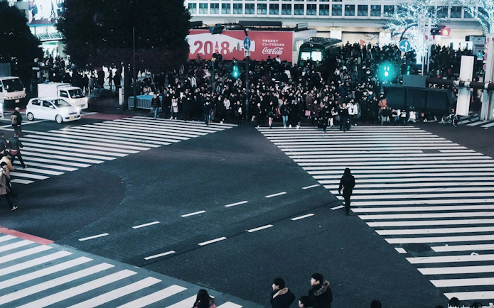 Crowd at Shibuya Crossing in Tokyo during a guided walking tour with SHIBUYA SKY admission.