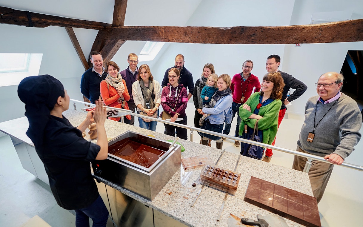 Visitors watching a chocolate-making demonstration at Choco Story Brussels.