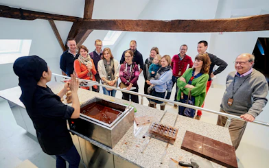 Visitors watching a chocolate-making demonstration at Choco Story Brussels.