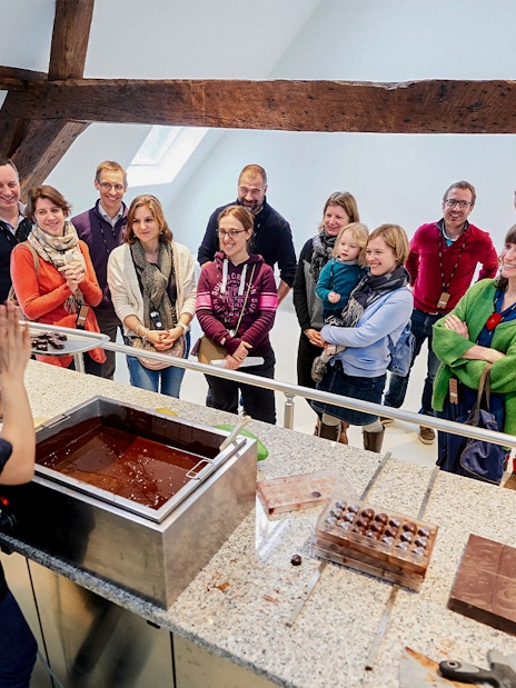Visitors watching a chocolate-making demonstration at Choco Story Brussels.