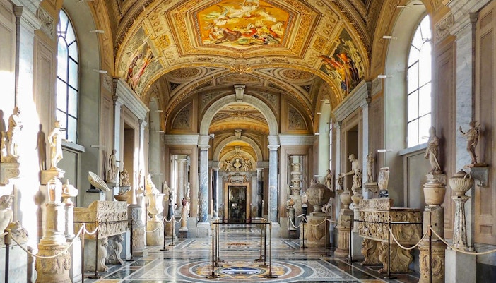 Vatican Museum Gallery visitors admiring artwork in Sistine Chapel, Rome.