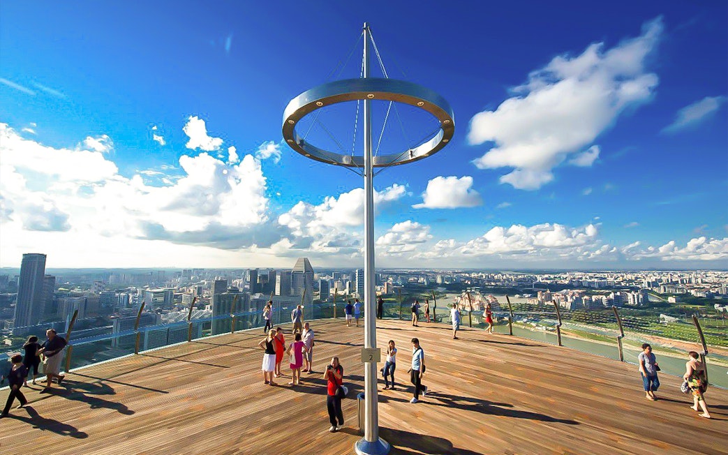 Visitors enjoying the view from Marina Bay Sands SkyPark Observation Deck, Singapore.