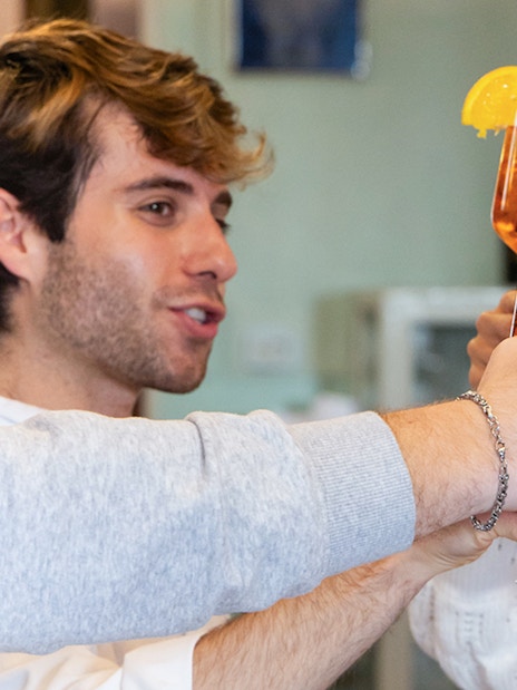 People toasting with Aperol Spritz at a Rome cooking class.