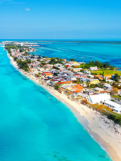 Aerial view of Bimini coastline, Bahamas, with turquoise waters and beachfront houses.