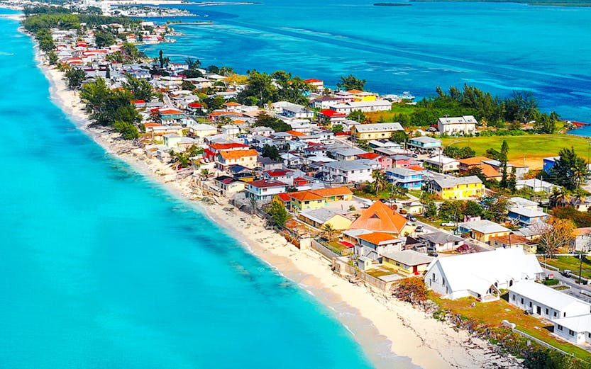 Aerial view of Bimini coastline, Bahamas, with turquoise waters and beachfront houses.