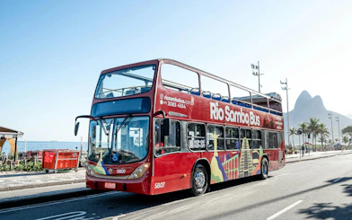 Rio Samba Bus on a sunny street in Rio de Janeiro with mountains in the background.