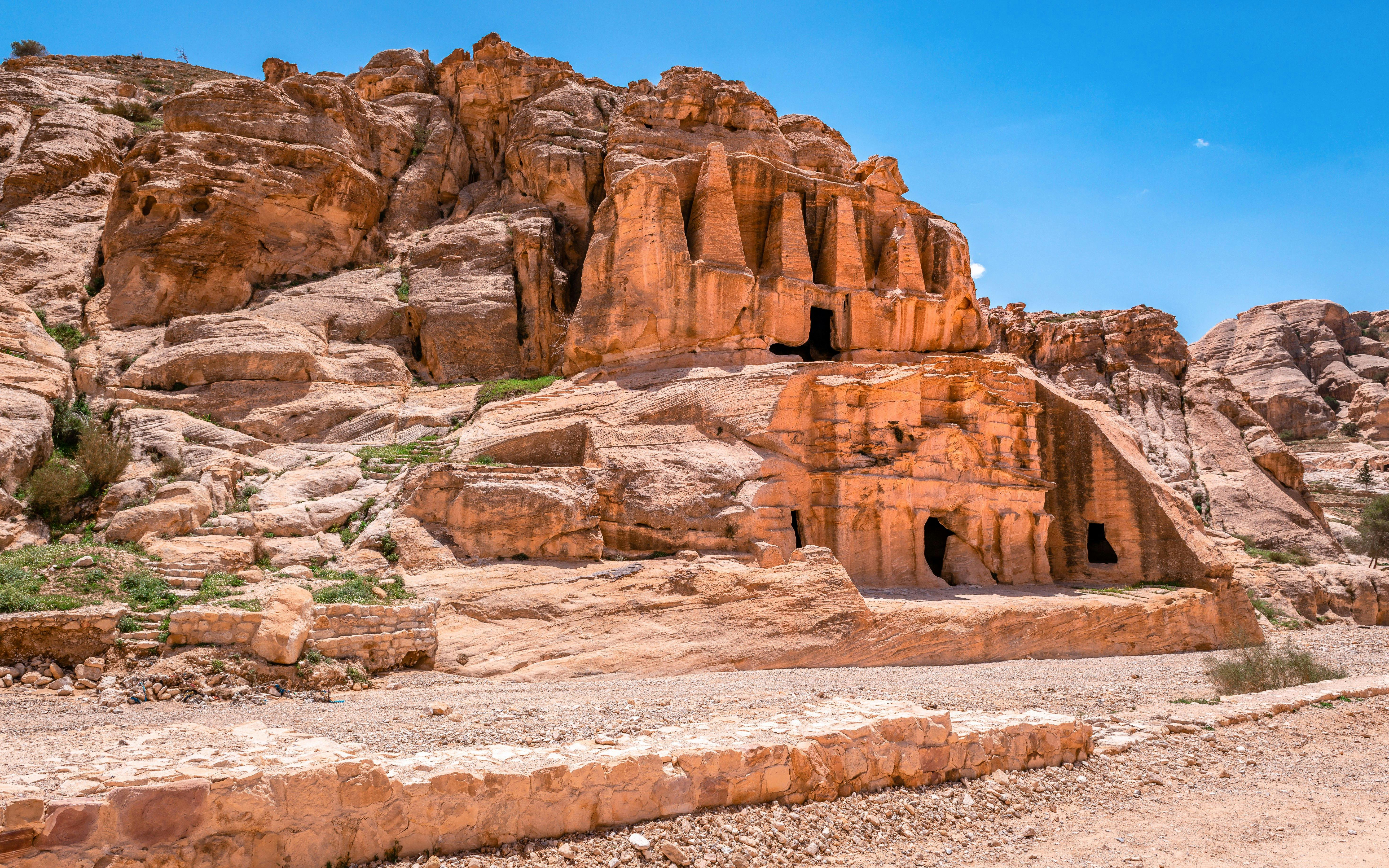 Nabataean tombs carved into sandstone cliffs in Petra, Jordan.