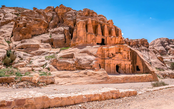 Nabataean tombs carved into sandstone cliffs in Petra, Jordan.
