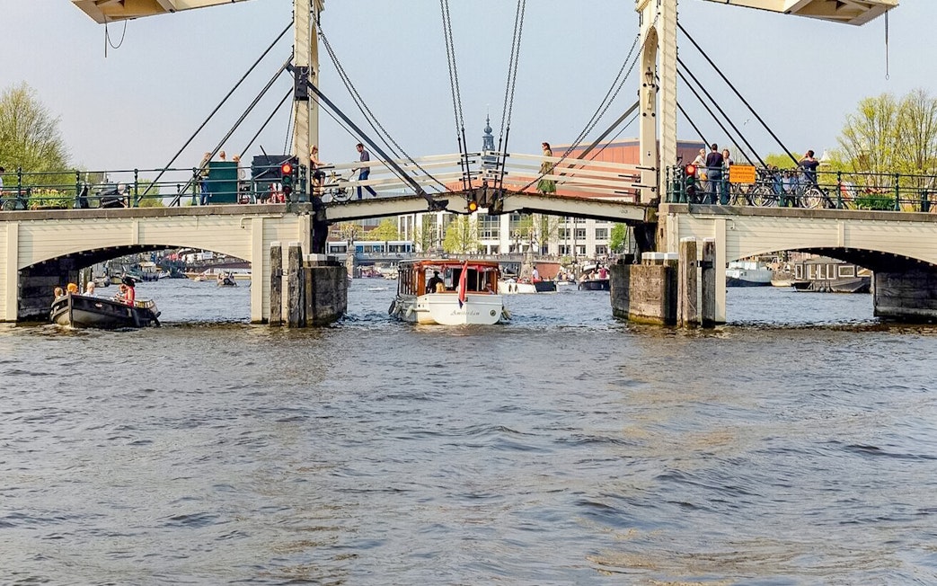 Boat passing under Amsterdam's Magere Brug on a canal cruise.