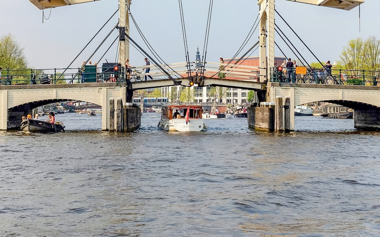 Boat passing under Amsterdam's Magere Brug on a canal cruise.