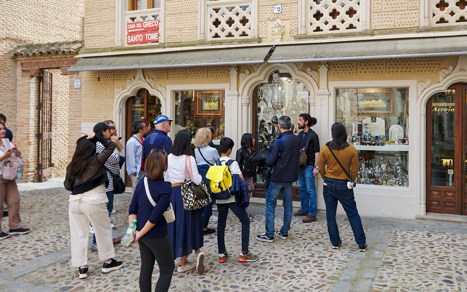 Participants exploring Toledo Old Town on a guided tour, with historic architecture in the background.