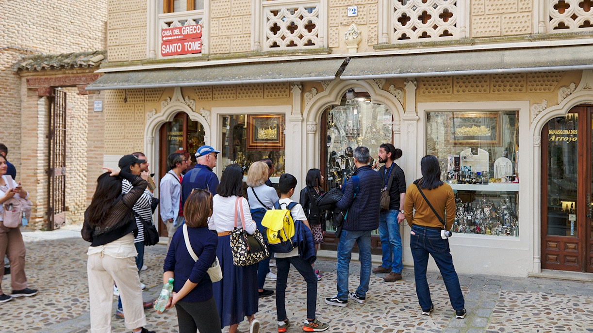 Participants exploring Toledo Old Town on a guided tour, with historic architecture in the background.