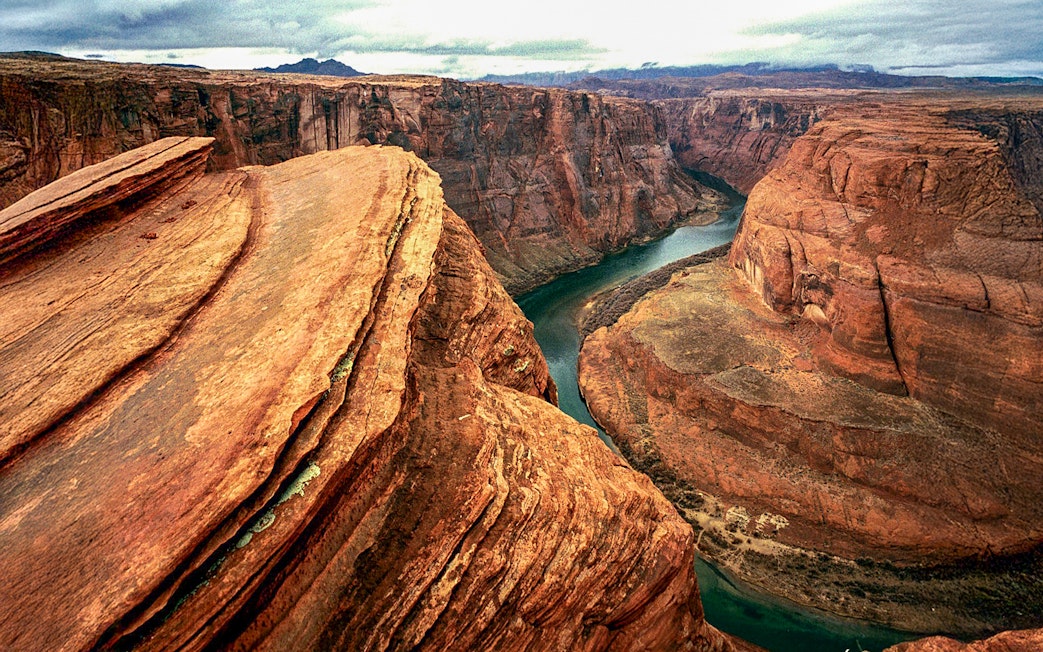 Aerial view of Horseshoe Bend's curved canyon and river during a helicopter tour.