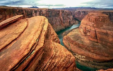 Aerial view of Horseshoe Bend's curved canyon and river during a helicopter tour.