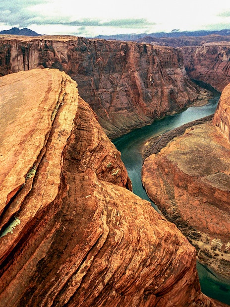 Aerial view of Horseshoe Bend's curved canyon and river during a helicopter tour.