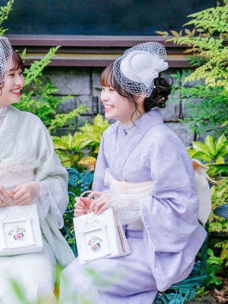 Visitors wearing kimonos in a garden in Kyoto Arashiyama.