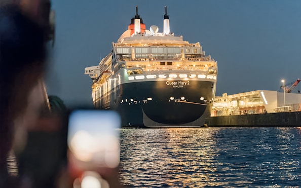 Large cruise ship illuminated at night during a 1.5h Grand Evening Lights Cruise.