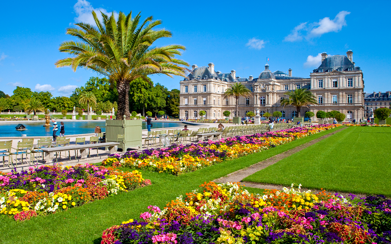 Luxembourg Park gardens with colorful flowers and the palace in the Latin Quarter, Paris.