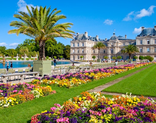 Luxembourg Park gardens with colorful flowers and the palace in the Latin Quarter, Paris.