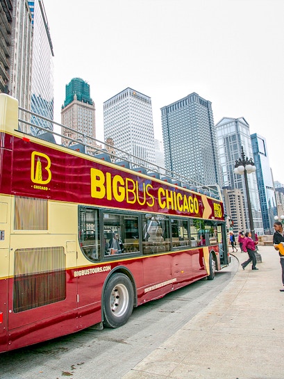 Open-top Big Bus Chicago tour in downtown with skyscrapers in the background.