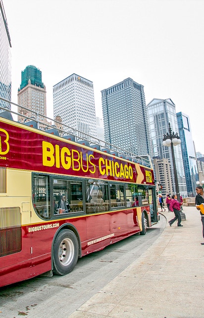 Open-top Big Bus Chicago tour in downtown with skyscrapers in the background.