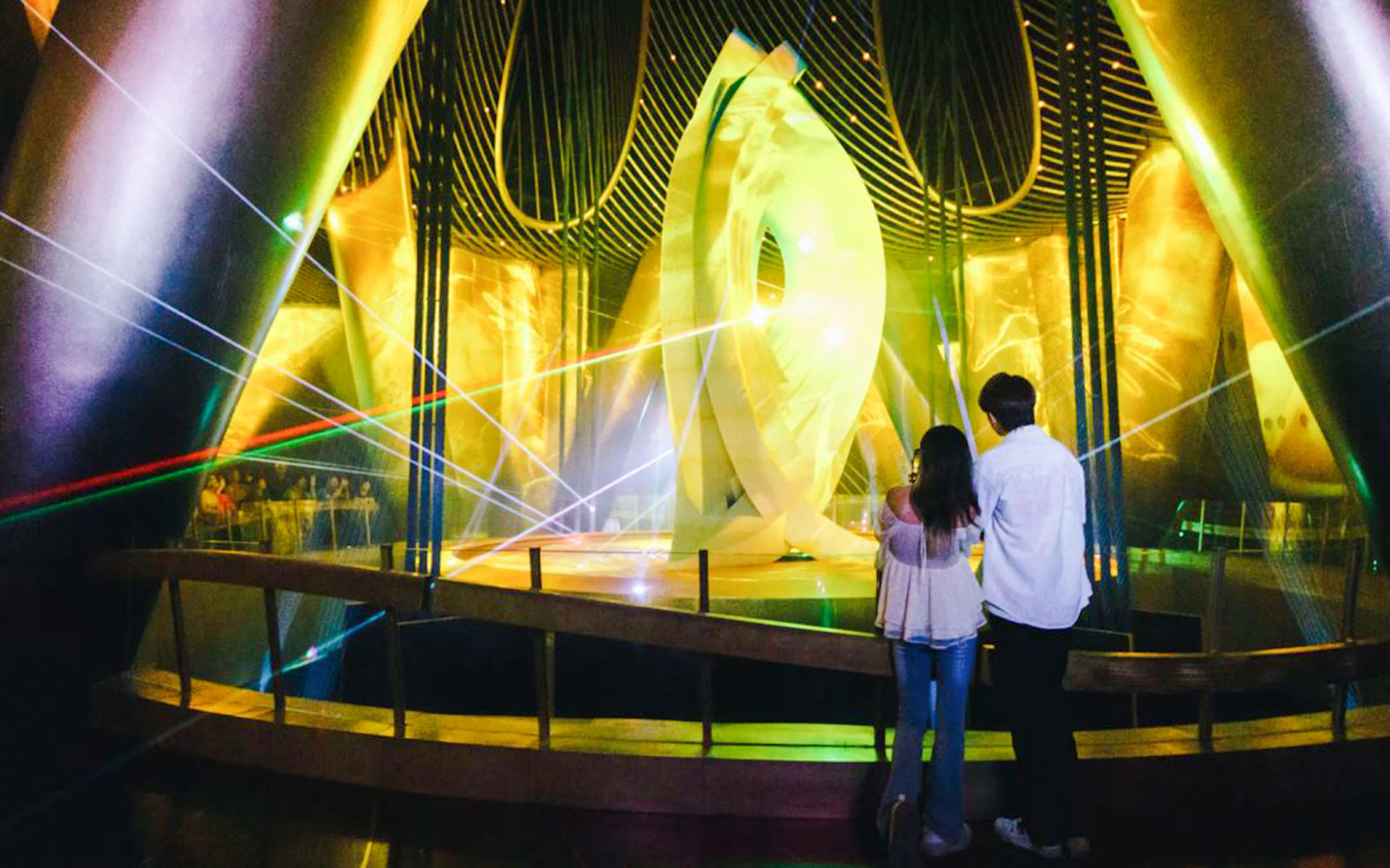 Visitors observing a light display inside Shanghai Tower.