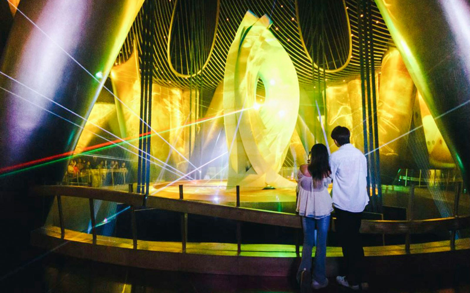 Visitors observing a light display inside Shanghai Tower.