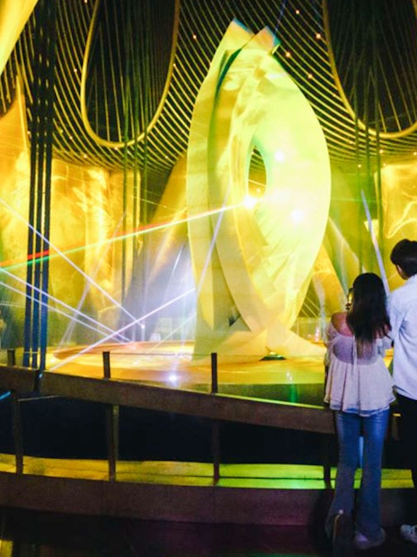 Visitors observing a light display inside Shanghai Tower.