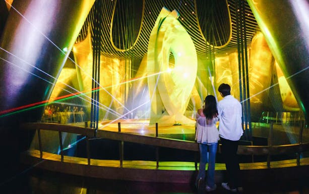 Visitors observing a light display inside Shanghai Tower.