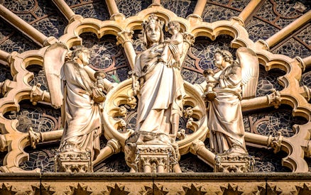 Notre-Dame Cathedral facade statues in Paris, featuring religious figures.