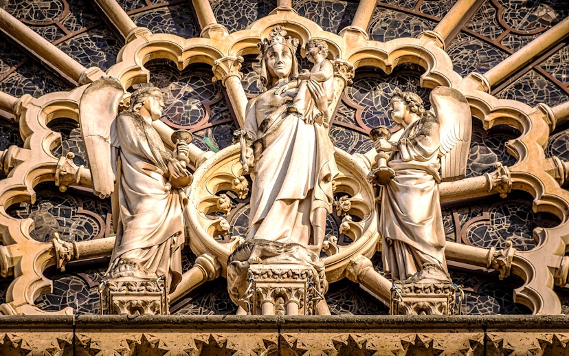 Notre-Dame Cathedral facade statues in Paris, featuring religious figures.